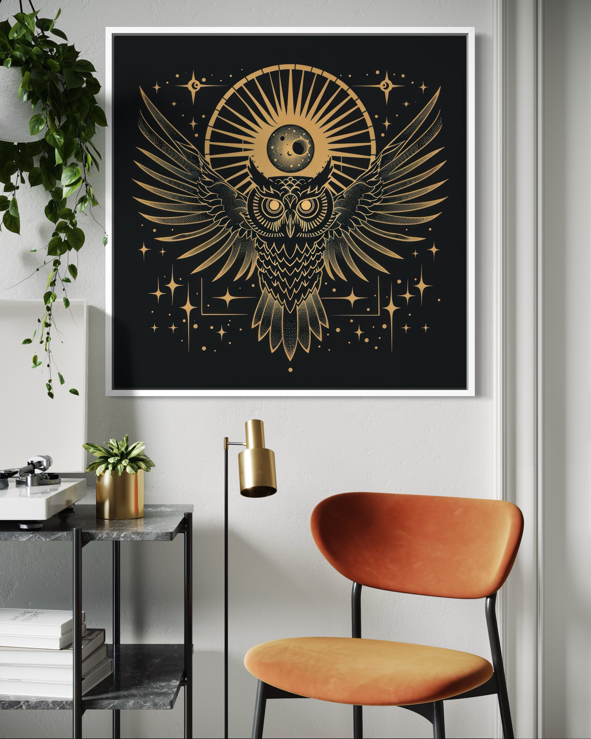 Gold owl artwork in black frame with starburst and wing details